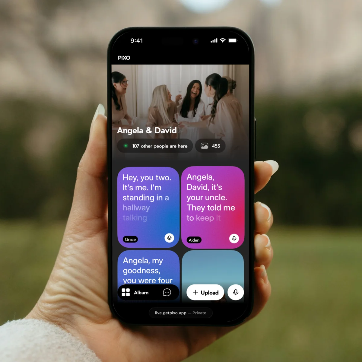 A hand holding a phone open to a wedding's live feed, where two guests' voice messages show as cards with their words written out